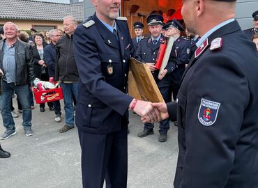 Marcel Reif (stellv. Ortswehrführer Döbern) überreicht Gastgeschenk an Olaf Hanusch (Ortswehrführer Halbendorf)