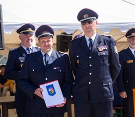 Ortswehrführer Toni Kärgel kann sich über eine Zuwendung des KFV SPN zum Jubiläum freuen, überreicht vom Vorstand für Kinder- und Jugendarbeit Stefan Kothe